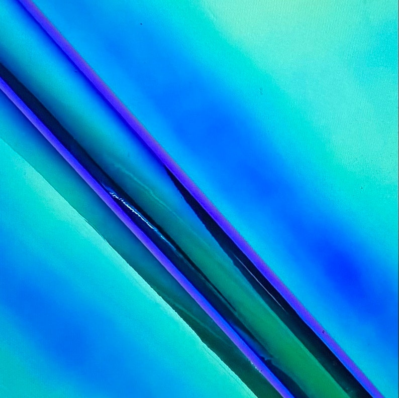 May include: A close-up of iridescent blue and purple vinyl wrap with a glossy finish.