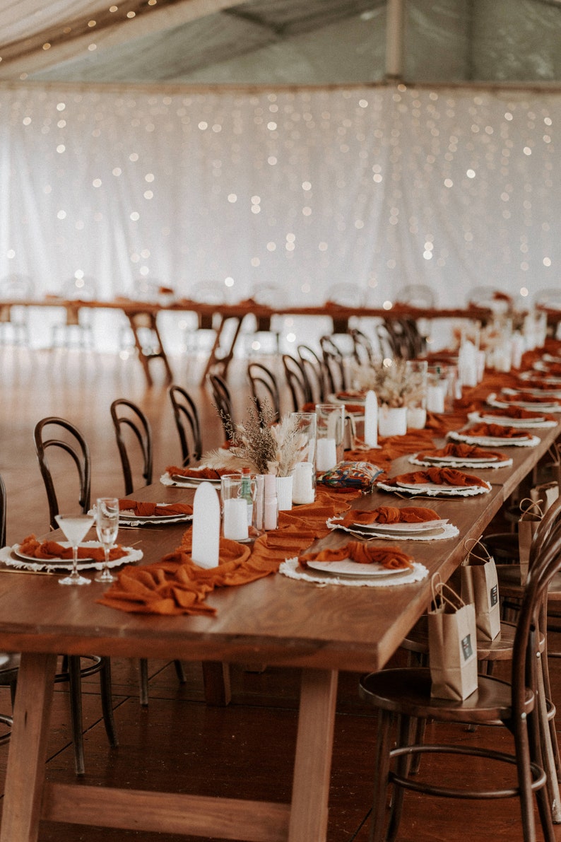 These gorgeous rust rustic table runners will add a beautiful, airy texture to your wedding table decor. This rust table runner is one of the most popular used for wedding, events and dinner settings.