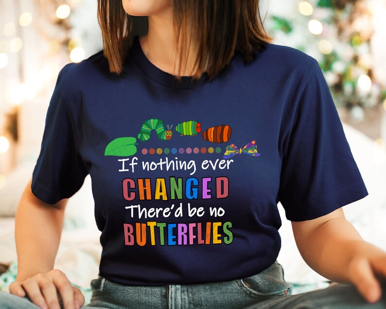 May include: A navy blue t-shirt featuring a colourful caterpillar graphic and the text "If nothing ever CHANGED There'd be no BUTTERFLIES".