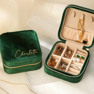 a green velvet case with jewelry inside of it