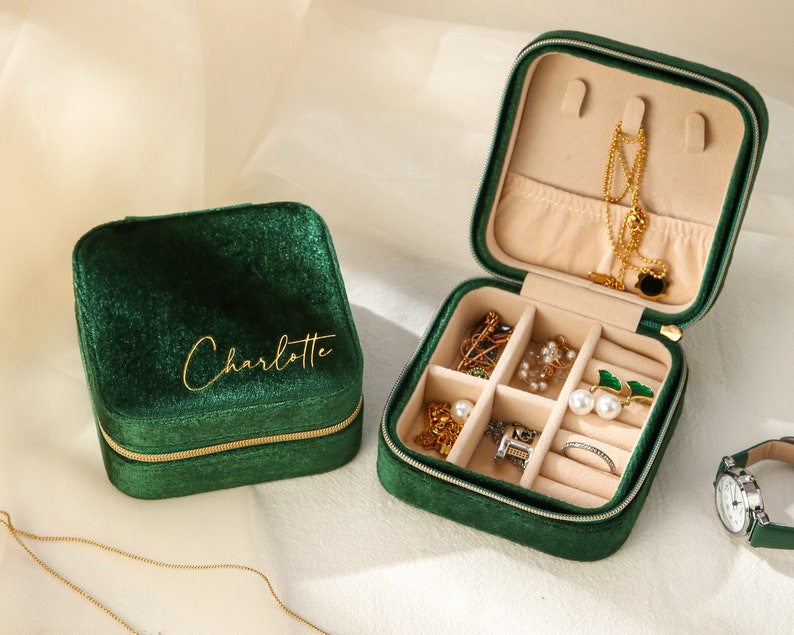 a green velvet case with jewelry inside of it