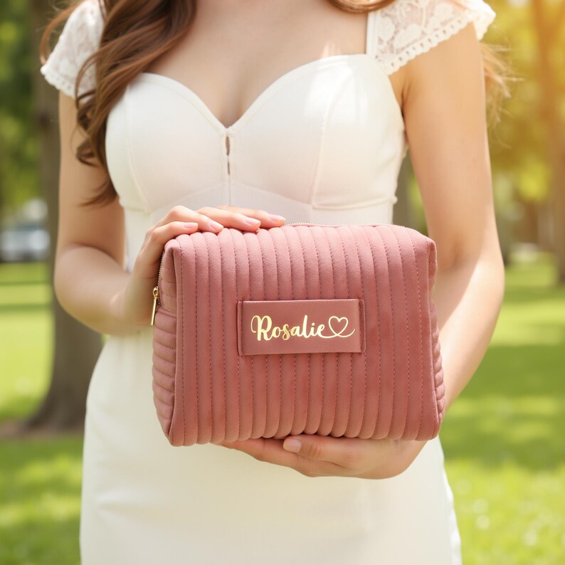 a woman in a white dress holding a pink purse