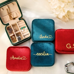 three personalized jewelry cases sitting on a table