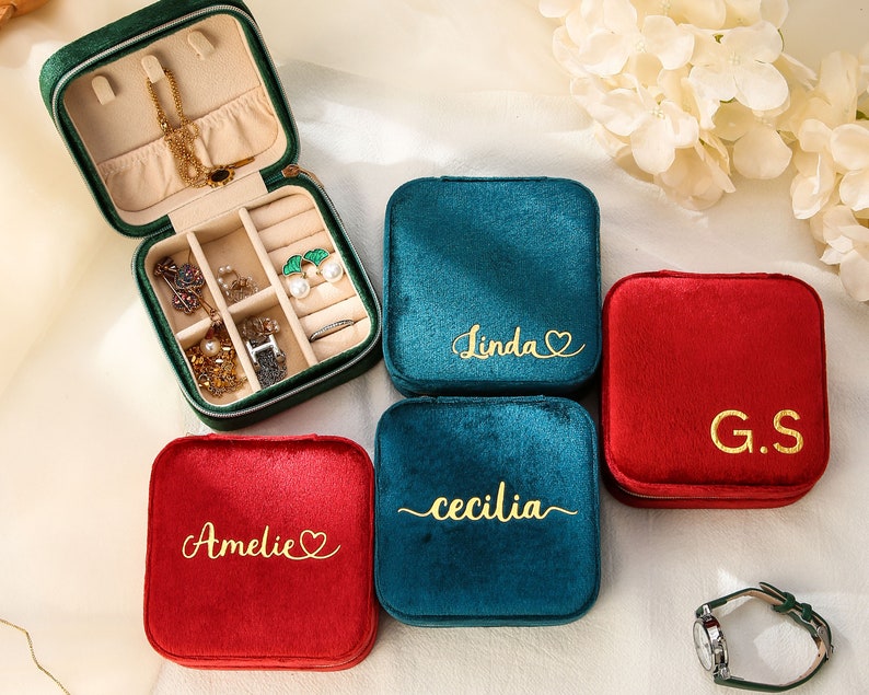 three personalized jewelry cases sitting on a table