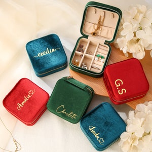 four personalized jewelry cases sitting on a table