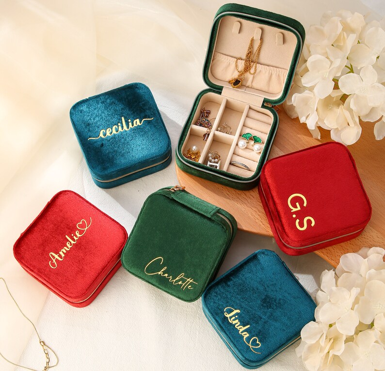 four personalized jewelry cases sitting on a table
