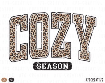 May include: A digital graphic with the word "COZY" in large, bold letters. The letters are filled with a leopard print pattern and outlined in black. Below, the word "SEASON" is in a black, distressed oval. The graphic is designed for apparel or home decor.