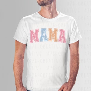 May include: A white t-shirt with the word "MAMA" printed in colorful block letters. The letters are outlined in black and have a vintage, distressed look.