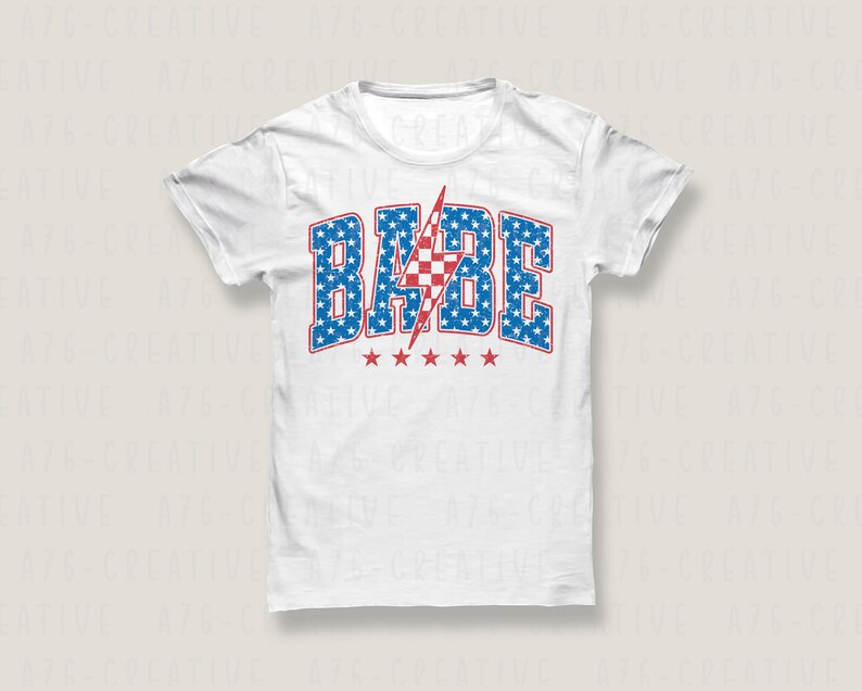 May include: White t-shirt with a red, white, and blue graphic that says "BABE" with a lightning bolt in the middle. The graphic is made up of stars and stripes.