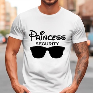 May include: White t-shirt with black text that reads "Princess Security" and a pair of sunglasses.