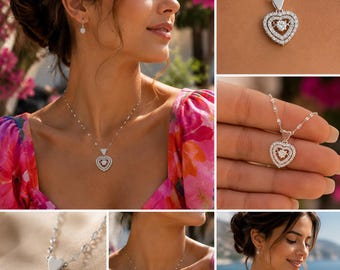 May include: A silver-toned necklace featuring a heart-shaped pendant with a central floating round stone surrounded by two rows of small clear stones. The chain consists of small, flat, reflective metallic links that catch the light.