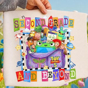 May include: A beige fabric pouch featuring a colorful graphic of Toy Story characters inside a purple bag. The text reads SECOND GRADE AND BEYOND with TOY STORY 5 printed on the bag. The design includes planets, stars, and rockets in a vibrant style.