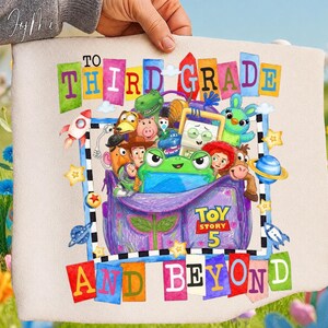May include: A beige fabric pouch featuring a colorful graphic print with the text TO THIRD GRADE AND BEYOND. The design includes various animated characters, a purple backpack, rockets, stars, planets, and a Toy Story 5 logo in the center.
