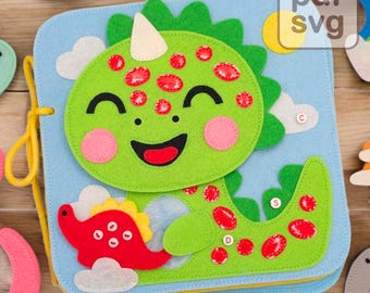 May include: A felt book for children featuring a green dinosaur with red spots and a smiling face. The dinosaur is holding a smaller red dinosaur with white clouds in the background. The book has a yellow string for tying it closed.