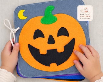 May include: A square felt book featuring a large orange jack-o'-lantern with a green stem and black facial features on a blue background, accompanied by a yellow crescent moon. A white cord is attached to the side, and a label reads PDF / SVG PATTERN & TUTORIAL.
