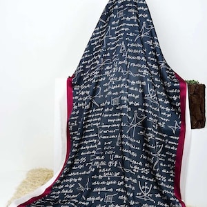 May include: A dark blue scarf with a white mathematical formula print and a burgundy border.