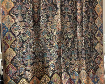 May include: An elaborate textile with a dark base and detailed patterns in gold, blue, green, and red. The design includes floral and geometric elements, with a decorative border along the bottom edge.