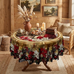 May include: A round table covered with a festive tablecloth featuring red poinsettias, pinecones, and gold ornaments. On the table sits a ceramic vase with dried pampas grass, a teapot, a teacup, a plate of cookies, and two lit candles.
