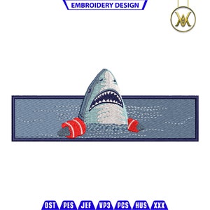 May include: Embroidered patch of a blue shark with red inner tubes, swimming in blue water. The patch is rectangular and has a blue background with white stitching.