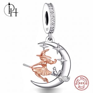 May include: A sterling silver charm featuring a rose gold-toned figure of a witch riding a broomstick with a small cat, set against a silver crescent moon with three four-pointed stars. The bail is encrusted with clear stones and stamped 925.