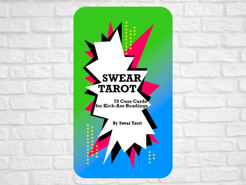 May include: A green, blue and pink tarot card with a white starburst shape. The text on the card reads "SWEAR TAROT 78 Cuss Cards for Kick-Ass Readings By Swear Tarot".
