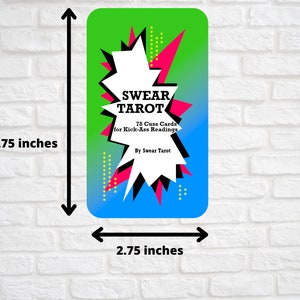 May include: A green, pink and blue tarot card with a black and white starburst design. The card reads "SWEAR TAROT" and "78 Cuss Cards for Kick-Ass Readings, By Swear Tarot".
