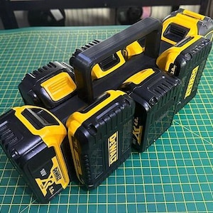 May include: A black and yellow tool battery storage case with a handle. The case holds six batteries, each labelled "DEWALT 20V MAX".