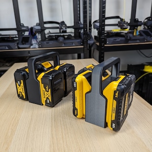 May include: Two black and grey battery holders with two yellow and black DeWalt 18V 3.0Ah batteries in each holder.