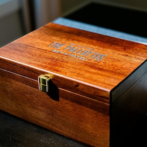 May include: A wooden box with a brass latch. The box is engraved with "The Pallottis" and "Ben & Nayeli".