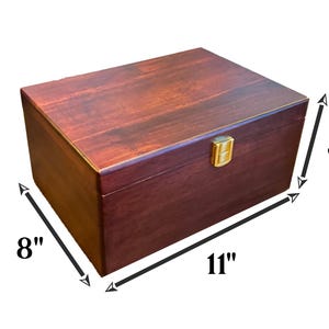 May include: A dark red wooden box with a gold latch. The box measures 11 inches long, 8 inches wide, and 5.25 inches tall.