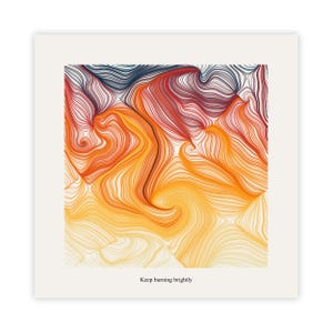 May include: Abstract art print with a swirling design of orange, red, and yellow lines on a white backdrop. The artwork has a gradient effect, with darker colours at the top and lighter shades at the bottom. The text "Keep burning brightly" is at the bottom.