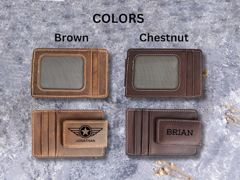 May include: Two leather wallets with a money clip. The wallet on the left is brown and has a star and the name "JONATHAN" engraved on it. The wallet on the right is chestnut brown and has the name "BRIAN" engraved on it.
