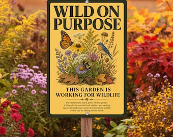 May include: A rectangular yellow metal sign with black text reading WILD ON PURPOSE and THIS GARDEN IS WORKING FOR WILDLIFE. The center features a detailed illustration of a monarch butterfly, a bluebird, a bumblebee, and wildflowers.