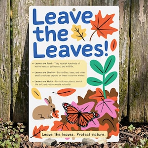 May include: A rectangular white sign with the blue text Leave the Leaves! and illustrations of a brown rabbit, a monarch butterfly, and colorful autumn leaves. It includes text explaining that leaves provide food, shelter, and mulch.