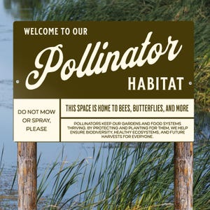 May include: A rectangular brown and cream metal sign with the text Welcome to our Pollinator Habitat. It includes instructions to not mow or spray, and states this space is home to bees, butterflies, and more, emphasizing biodiversity.