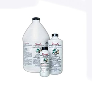 May include: Three white plastic bottles of Woods Rooting Compound, with black caps and labels. The largest bottle is a gallon jug, the middle bottle is a quart, and the smallest is a pint. The labels feature a green and white logo and product information.