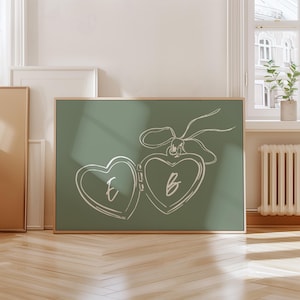 Puede incluir: Una impresión en lienzo verde con un dibujo de línea blanca de un medallón en forma de corazón con las letras "E" y "B" en su interior.