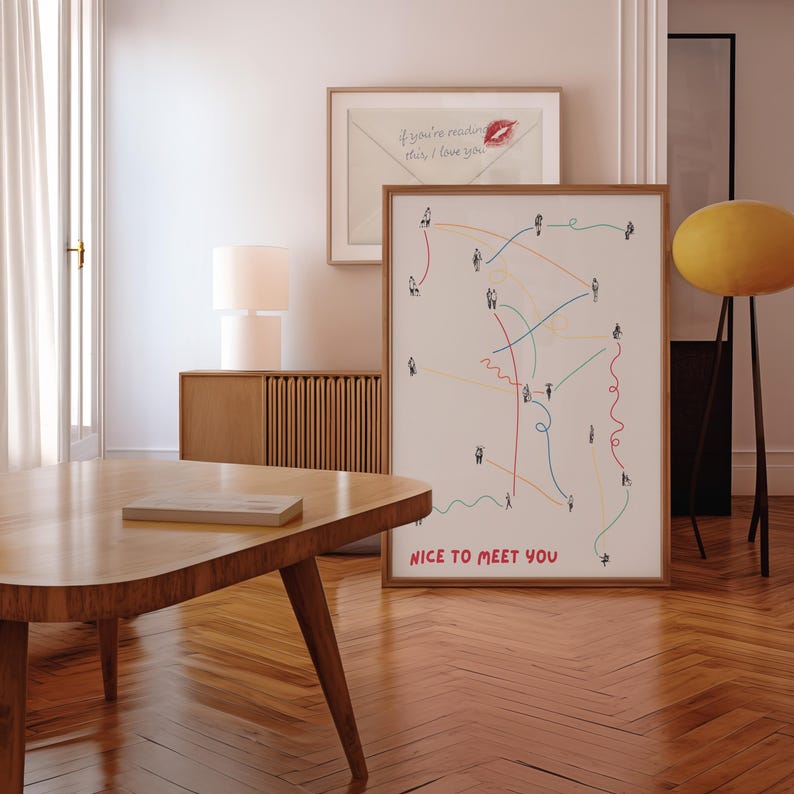 May include: A framed print with the words "NICE TO MEET YOU" displays a network of connecting lines and stick figures in multiple colours. Above, another framed print shows an envelope with the text "if you're reading this, I love you."