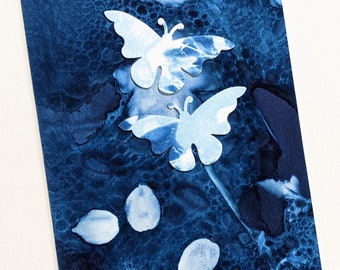 Cyanotype of buttercup petals and allium butterflies on watercolour paper, mounted to fit 8"x6" frame. A unique handmade print.
