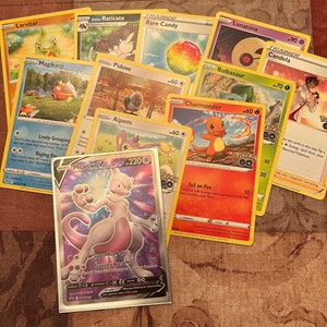 May include: A collection of Pokemon trading cards featuring various characters, including Mewtwo, Charmander, Bulbasaur, and Lunatone. The cards are in various colors, including yellow, red, blue, and green. The cards are arranged in a random order.