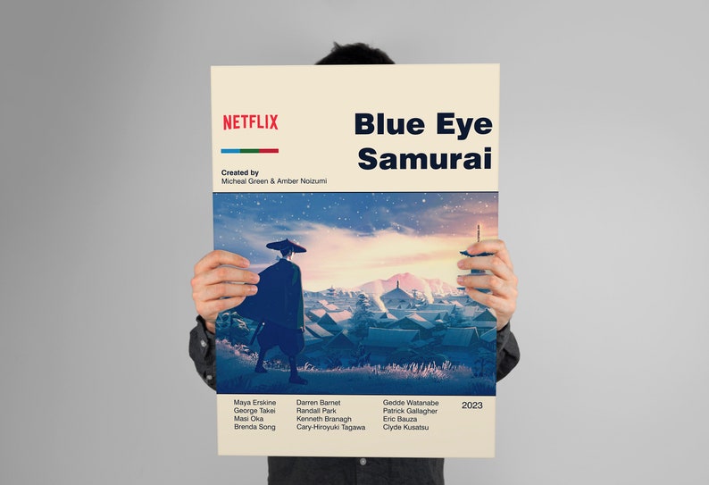 May include: A poster for the Netflix series "Blue Eye Samurai" featuring a stylized image of a samurai walking through a snowy village with a mountain in the background. The poster includes the title of the series, the creators' names, the cast, and the year 2023.