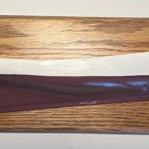 May include: A wooden plaque with a model of a white and burgundy lobster boat. The plaque has a brass plate with the text "Muscongus Bay Lobster Sloop Ranger 1889".