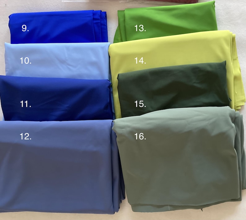 May include: A collection of eight folded fabric swatches arranged in two columns. The left column features shades of blue labeled 9 through 12, while the right column displays shades of green labeled 13 through 16, ranging from bright lime to muted olive.