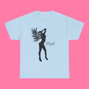 May include: A light blue t-shirt featuring a black silhouette graphic of a person with long flowing hair wearing high heels. The graphic includes the text iDgaf printed in a simple black font to the right of the silhouette figure on the chest.