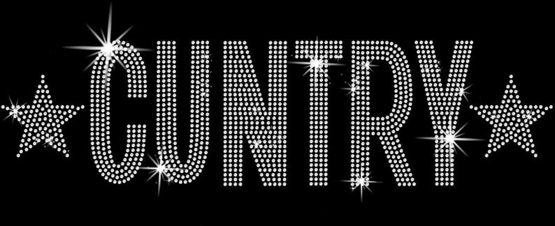 May include: The word "CUNTRY" in sparkling white rhinestones, with a star on each side, set against a black background. The letters are large and bold, with a slight sparkle effect.