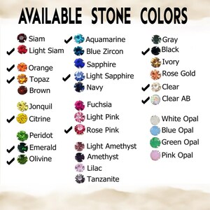 May include: A chart displaying a variety of gemstone colors, including Siam, Aquamarine, and Gray. The text "AVAILABLE STONE COLORS" is at the top. Check marks indicate available colors. The chart includes colors like Orange, Topaz, and Rose Pink.