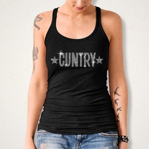May include: Black tank top with the word "CUNTRY" spelled out in sparkling rhinestones, with star accents. The top is a racerback style, and the text is centered on the chest.