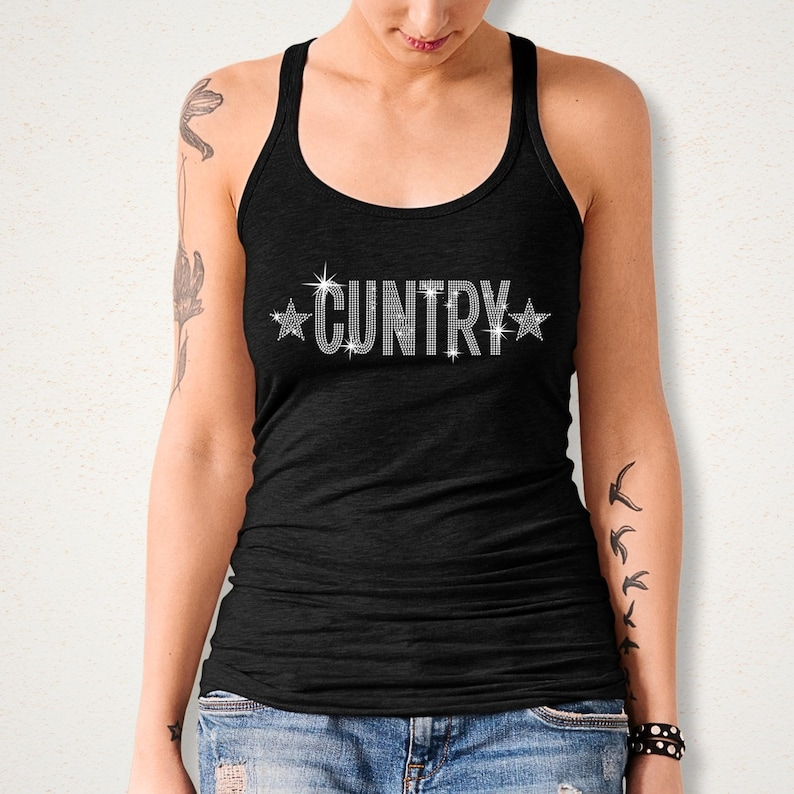 May include: Black tank top with the word "CUNTRY" spelled out in sparkling rhinestones, with star accents. The top is a racerback style, and the text is centered on the chest.