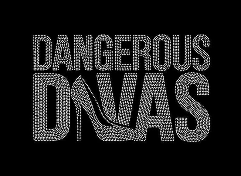 May include: Black graphic with the words "DANGEROUS DIVAS" in a sparkling, rhinestone-like font. A high-heeled shoe graphic is incorporated into the word "DIVAS". The design is set against a solid black background.