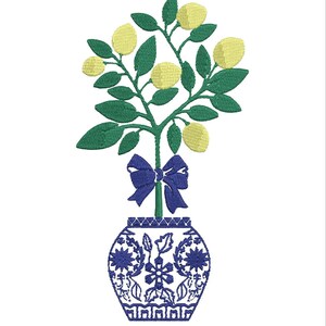 May include: A blue and white porcelain vase with a green lemon tree with yellow lemons and a blue bow.